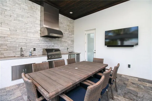 a kitchen with a wooden table and chairs
