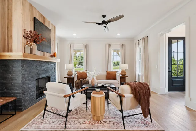 a table and chairs in a dining room with a chandelier