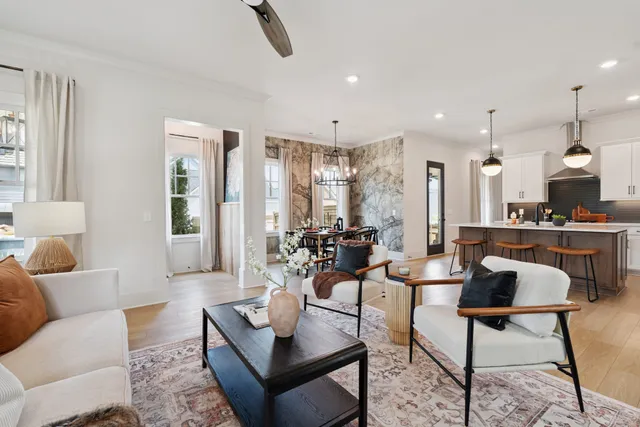a dining room with furniture a chandelier and wooden floor
