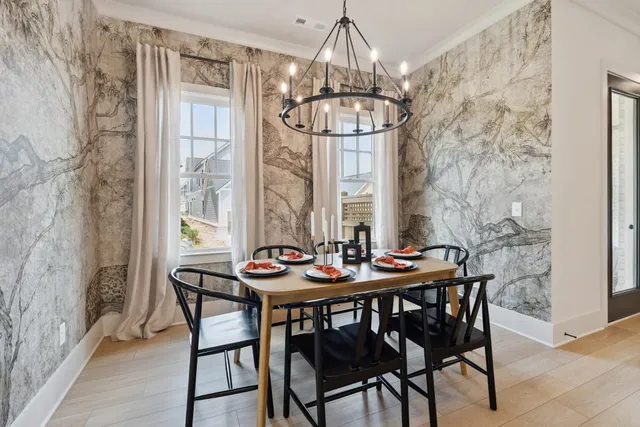 a kitchen with stainless steel appliances kitchen island granite countertop a refrigerator a stove a sink dishwasher and a dining table with wooden floor