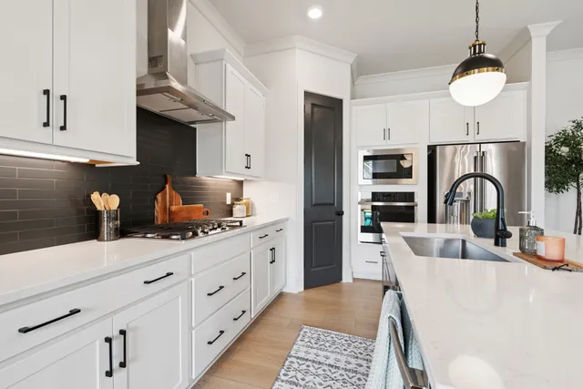 a bedroom with a bed and dresser with mirror