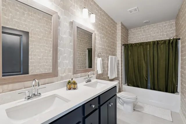 a city view with tall buildings and a cars park in front of it