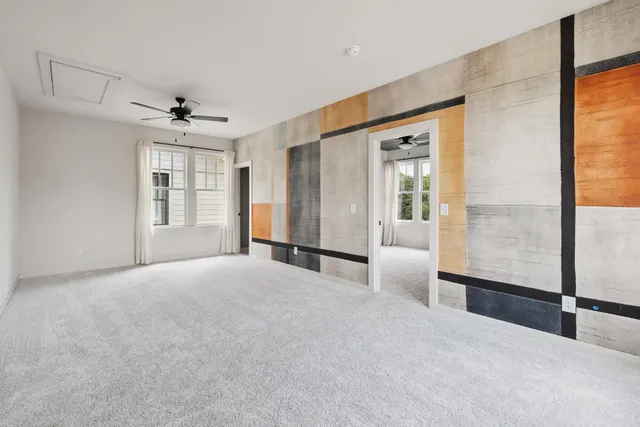 a living room with fireplace furniture and a large window