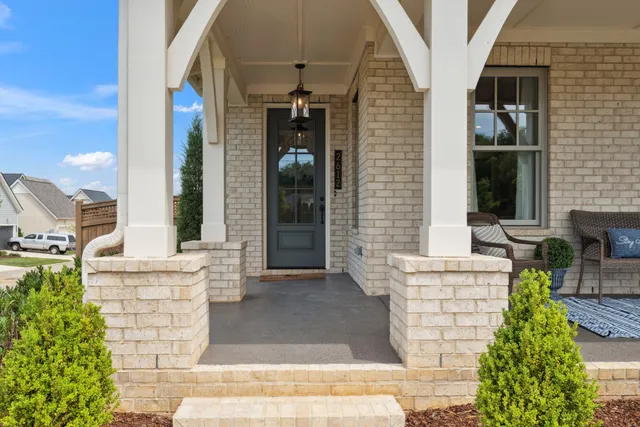 a view of a patio with couches table and chairs and potted plants