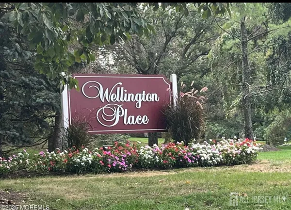 a sign that is in front of flowers