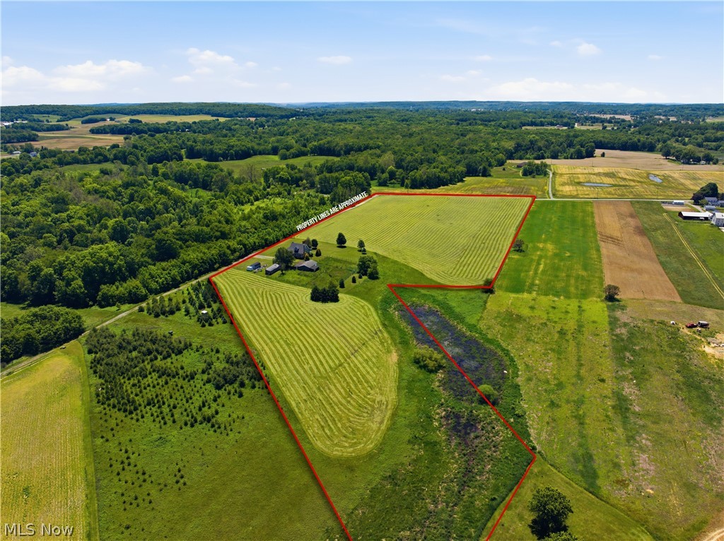 12159 Lawndell Road Southwest Beach City, OH 44608 - Photo 8 of 49 Expansive rural property featuring cultivated fields, wooded areas, and a visible pond