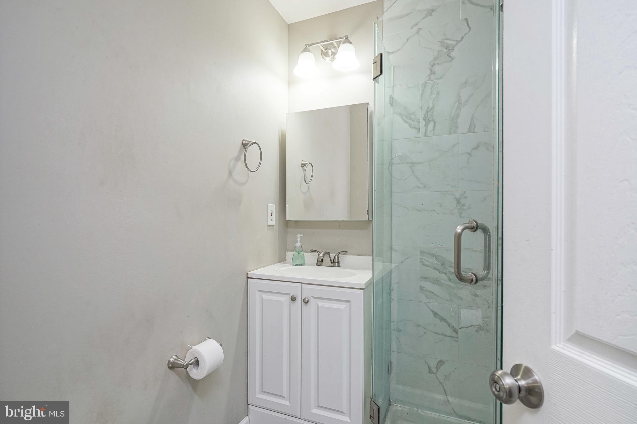 308 B Collins Lane Maple Shade, NJ 08052 - Photo 13 of 26 a bathroom with a sink mirror and vanity