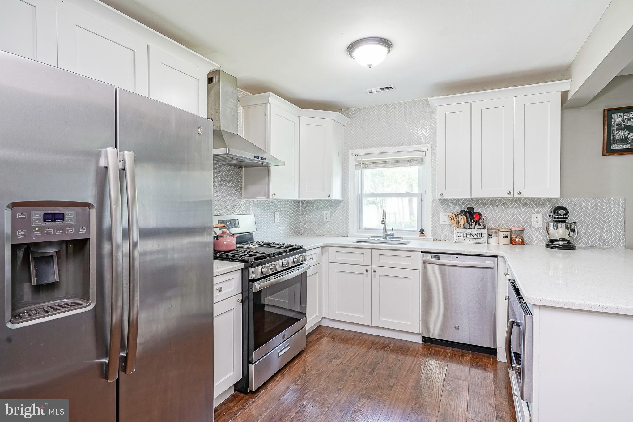 308 B Collins Lane Maple Shade, NJ 08052 - Photo 8 of 26 a kitchen with stainless steel appliances a stove a sink and a refrigerator