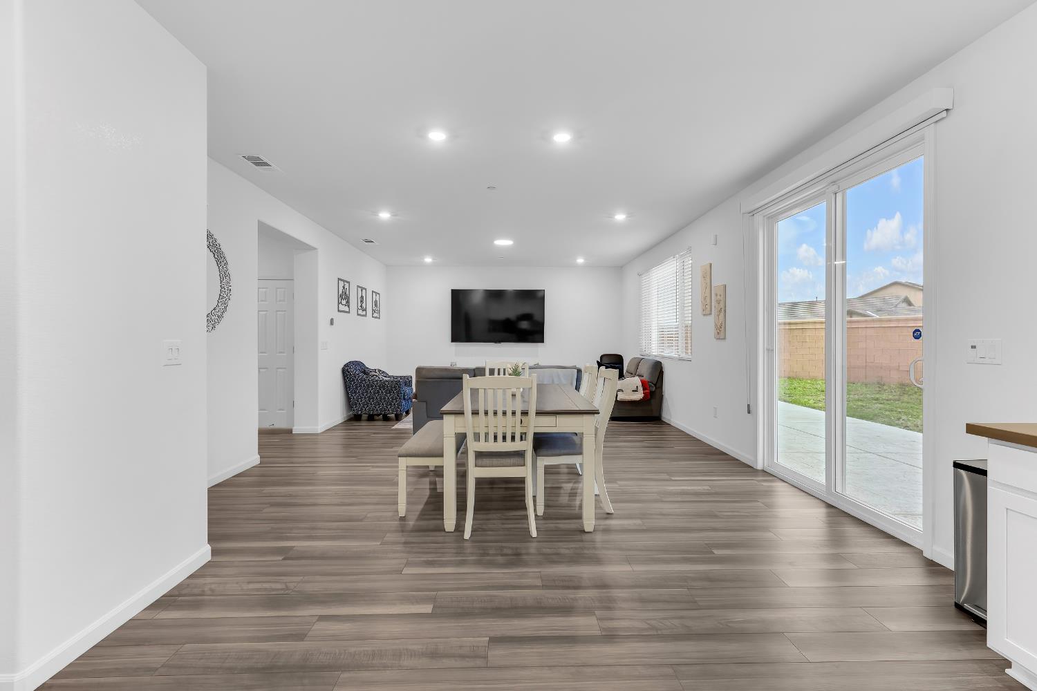 3600 Pride Way Stockton, CA 95212 - Photo 12 of 50 a living room with furniture a flat screen tv and a floor to ceiling window