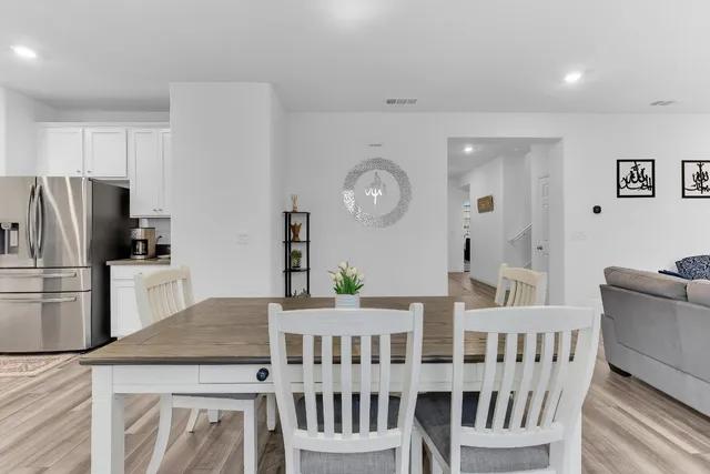 a kitchen with kitchen island a refrigerator and a stove top oven