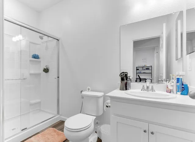 a bathroom with a sink toilet and shower