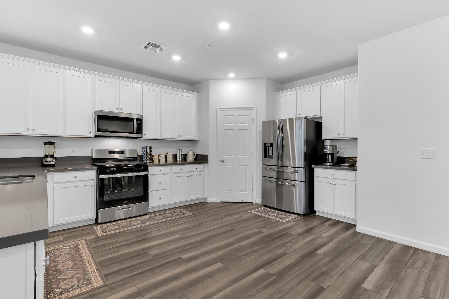 3600 Pride Way Stockton, CA 95212 - Photo 8 of 50 a kitchen with a refrigerator stove and microwave