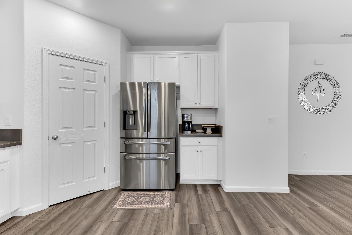 3600 Pride Way Stockton, CA 95212 - Photo 9 of 50 a kitchen with a refrigerator and wooden floor