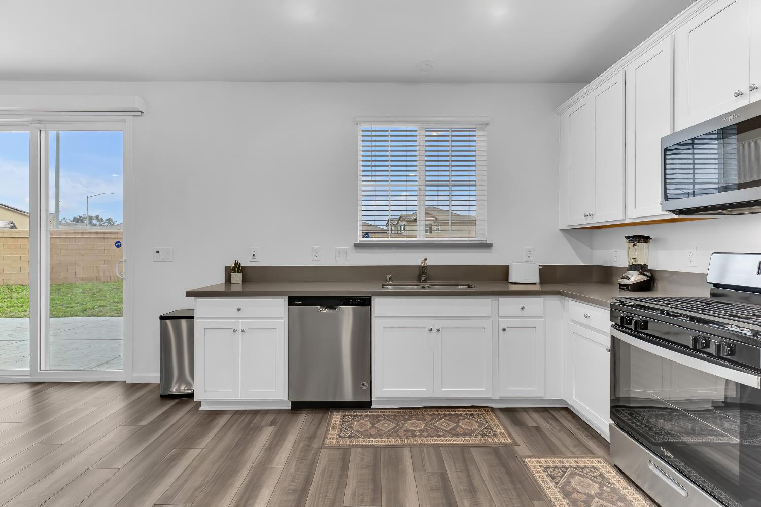3600 Pride Way Stockton, CA 95212 - Photo 10 of 50 a kitchen with stainless steel appliances granite countertop a stove a sink and a microwave