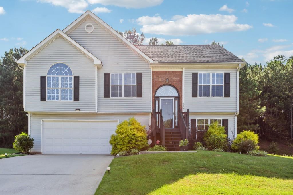 a front view of a house with a garden