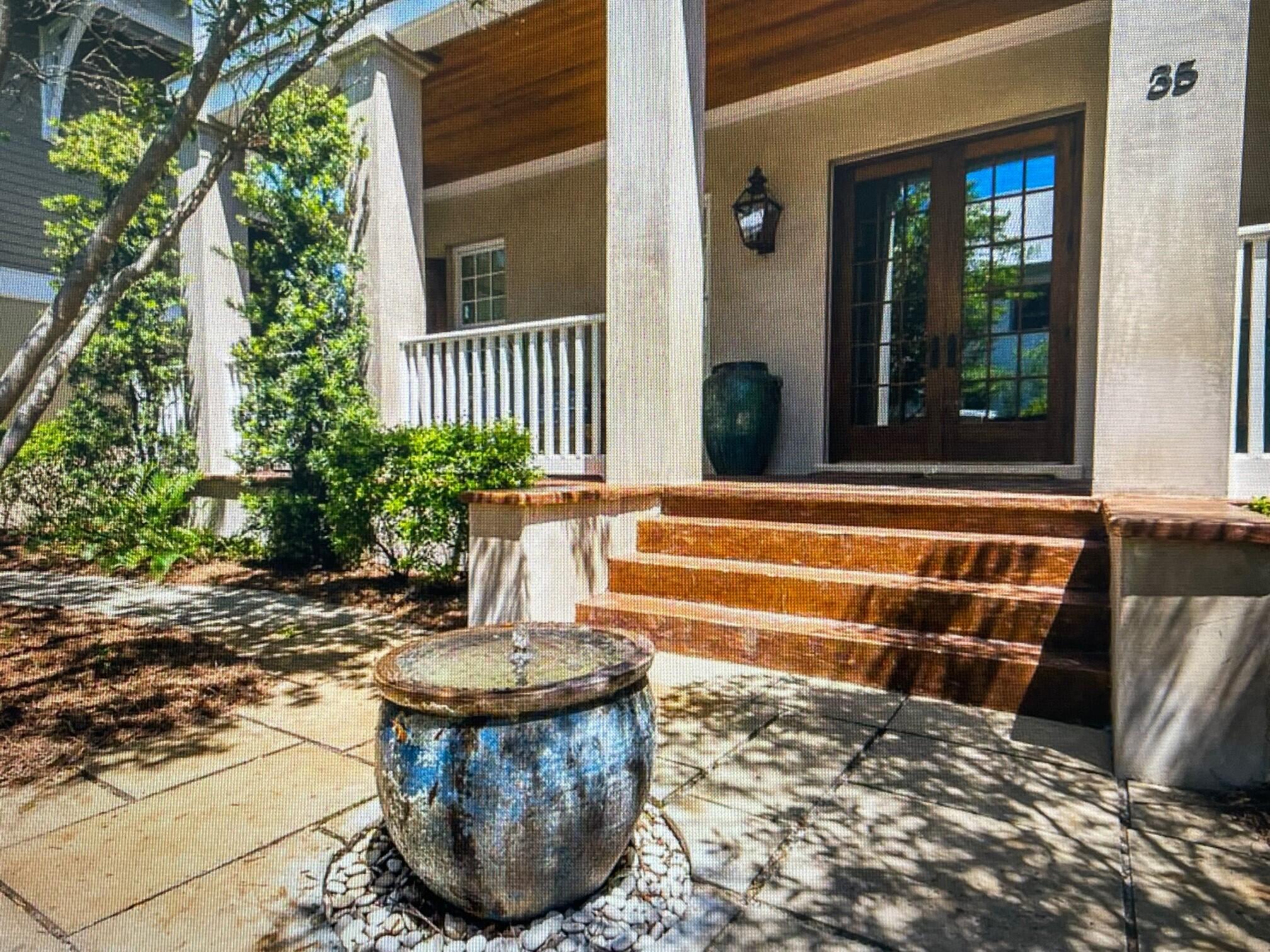 a view of a house with a small park side and a yard