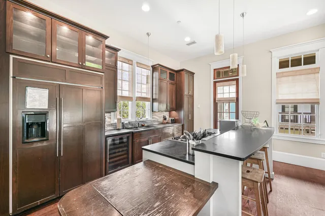 a kitchen with stainless steel appliances granite countertop a stove refrigerator and cabinets