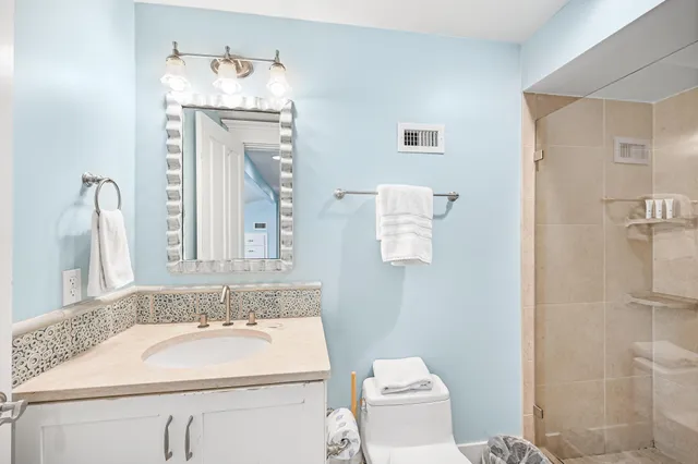a bathroom with a sink toilet and shower