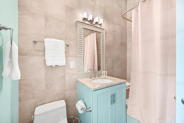 a bathroom with a sink a toilet and mirror