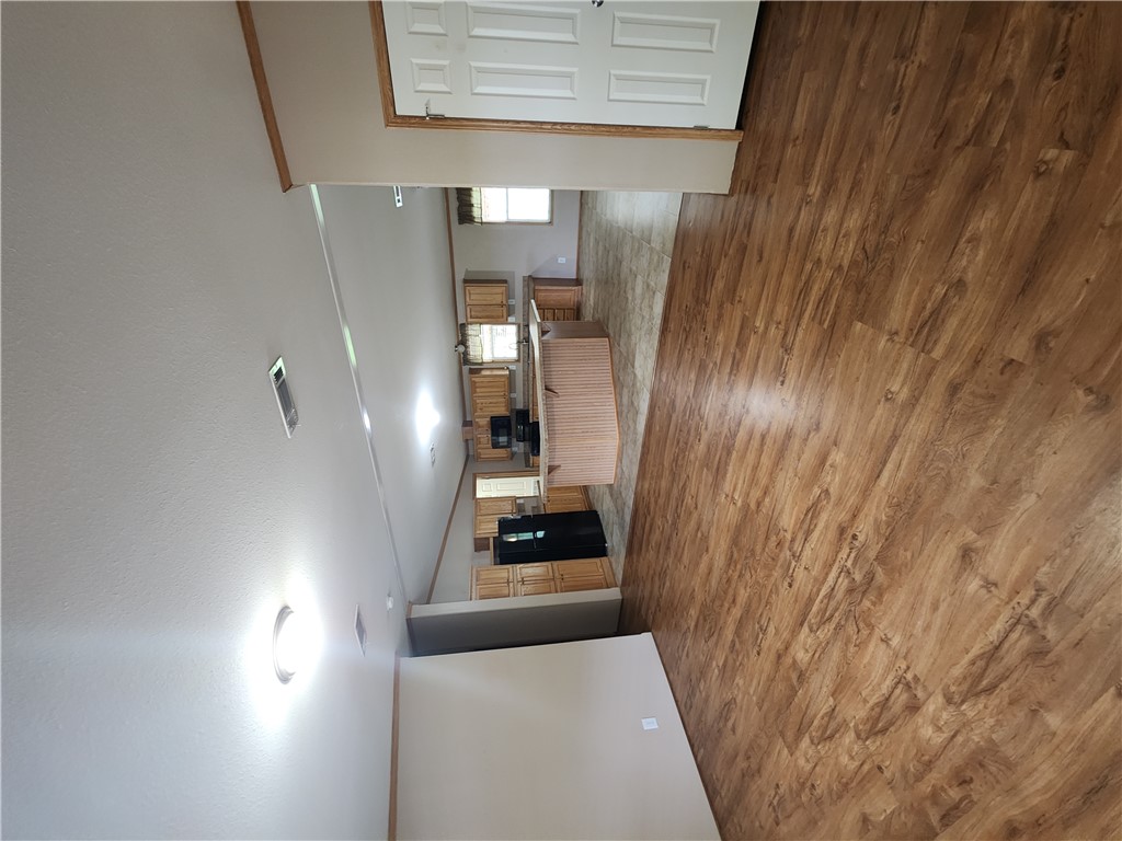 3738 Smetana Road Bryan, TX 77807 - Photo 3 of 29 an empty room with wooden floor and windows