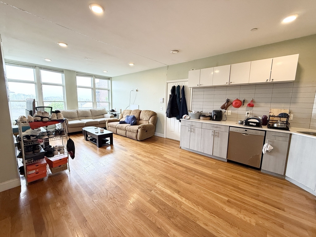 299 Dudley Street, Unit 7 Boston, MA 02119 - Photo 2 of 8 a living room with furniture and a wooden floor