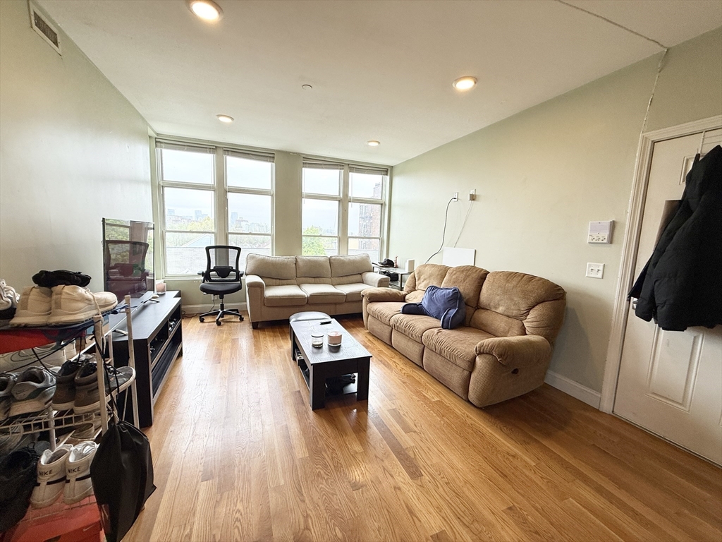 299 Dudley Street, Unit 7 Boston, MA 02119 - Photo 3 of 8 a living room with furniture flat screen tv and a large window