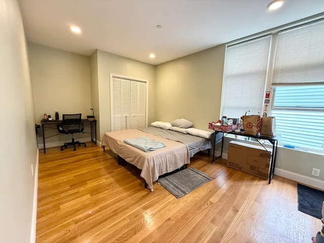 a spacious bedroom with a bed and a couch
