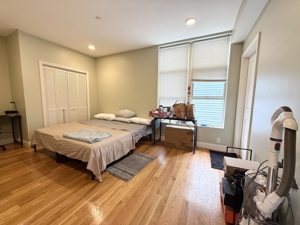 299 Dudley Street, Unit 7 Boston, MA 02119 - Photo 6 of 8 a spacious bedroom with a bed a dresser and a large window