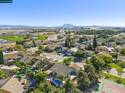 an aerial view of residential houses with outdoor space