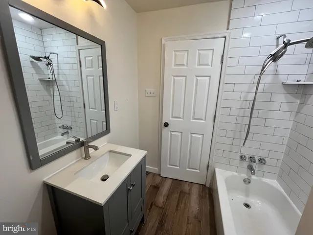 a bathroom with a sink a mirror and a bathtub