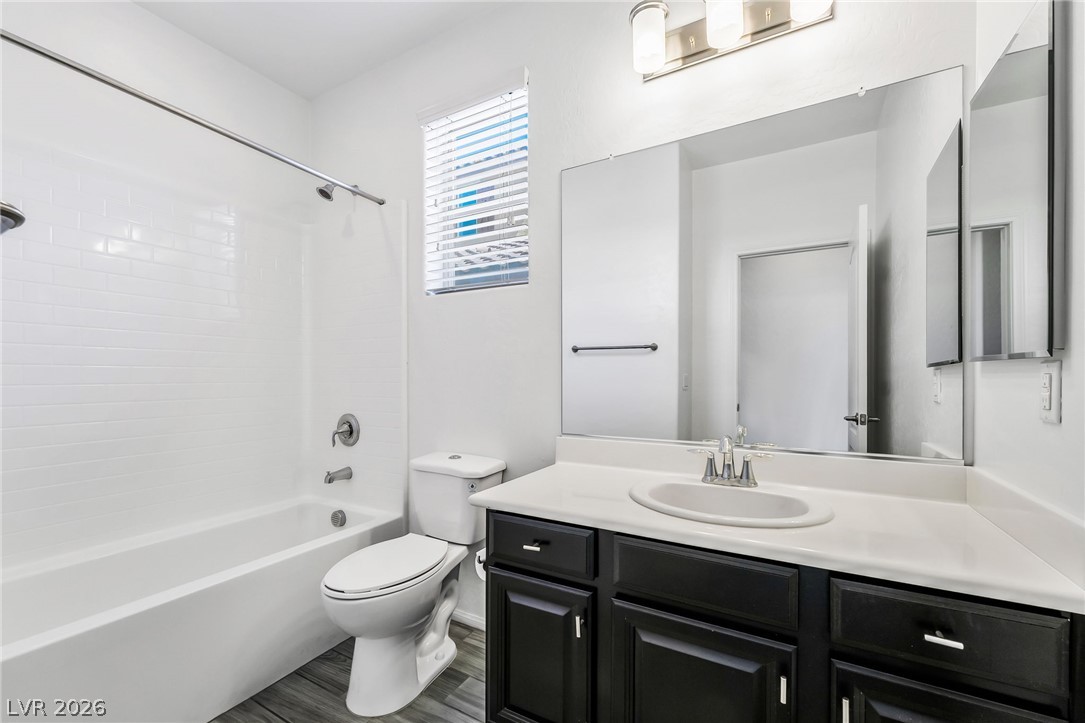 6245 Andover Wood Road Las Vegas, NV 89113 - Photo 26 of 37 A well-appointed bathroom features a bathtub, toilet, and vanity with ample counter space.