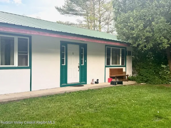 a view of a house with backyard and porch