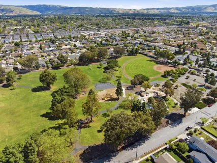 an aerial view of residential houses with outdoor space