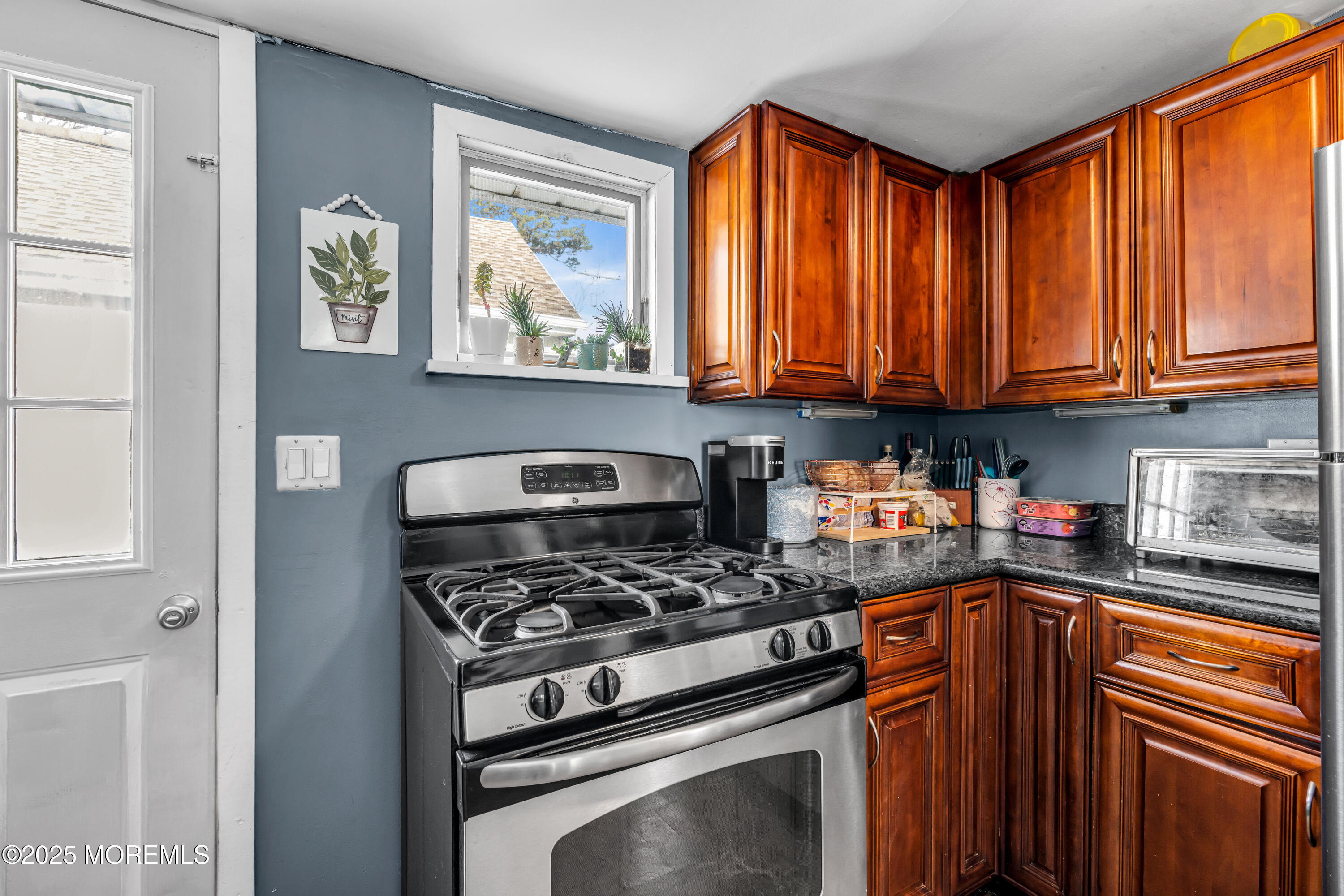 128 Pinehurst Road Brick, NJ 08723 - Photo 8 of 19 a kitchen with stainless steel appliances granite countertop a stove a sink and a microwave