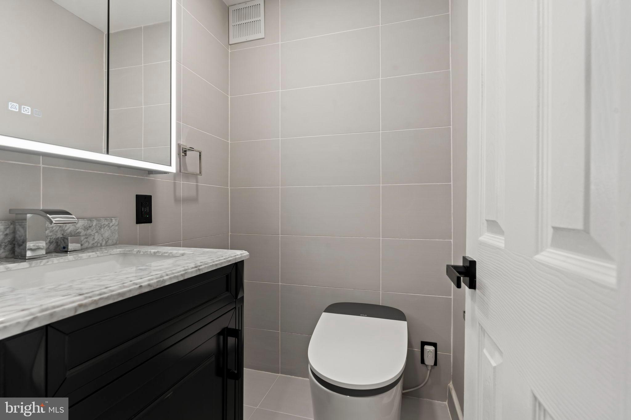 1600 Hagys Ford Road, Unit 3Y Narberth, PA 19072 - Photo 11 of 38 a bathroom with a granite countertop toilet sink and mirror