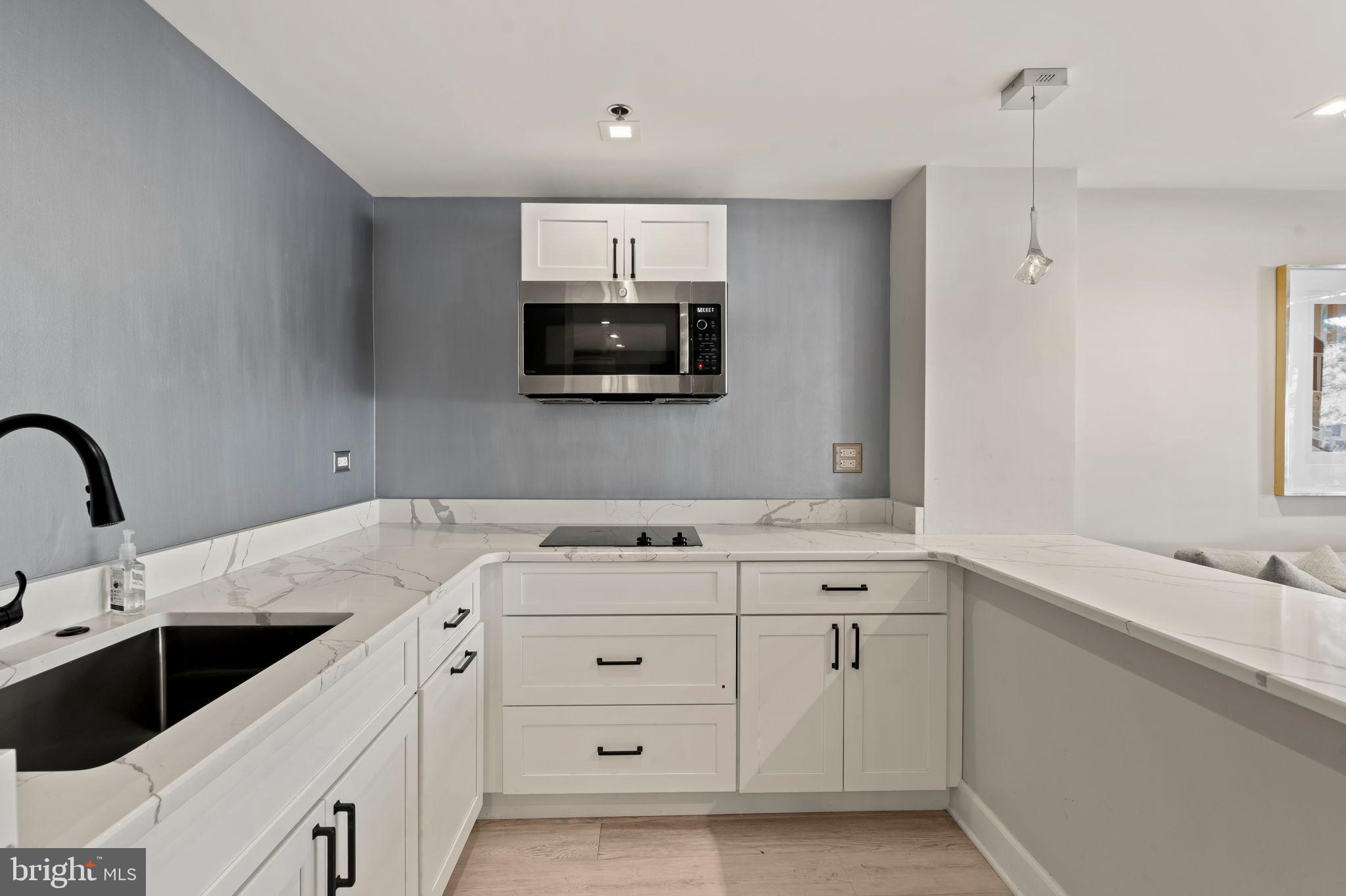 1600 Hagys Ford Road, Unit 3Y Narberth, PA 19072 - Photo 26 of 38 a kitchen with a sink stove and microwave