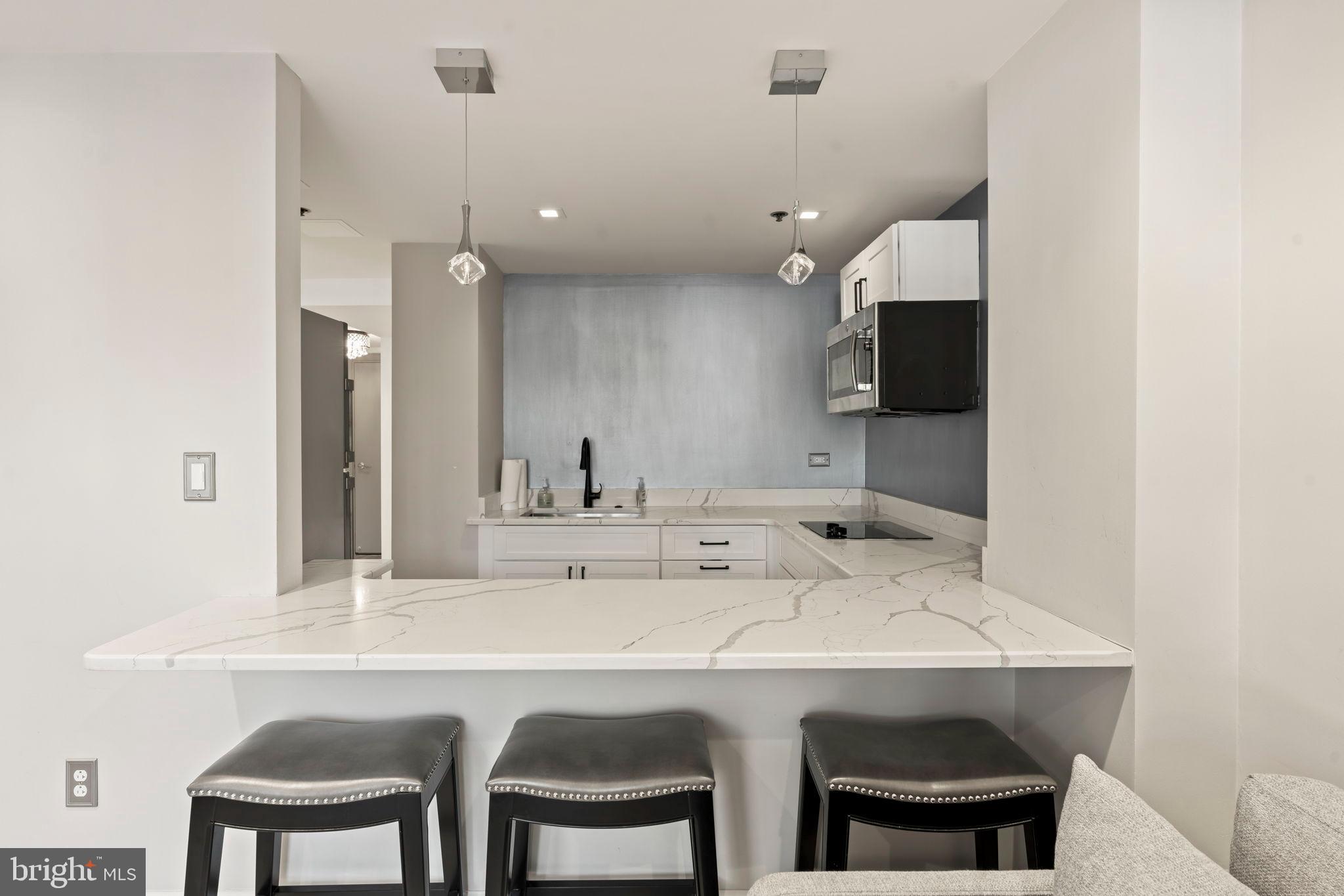 1600 Hagys Ford Road, Unit 3Y Narberth, PA 19072 - Photo 27 of 38 a kitchen with a sink and chairs