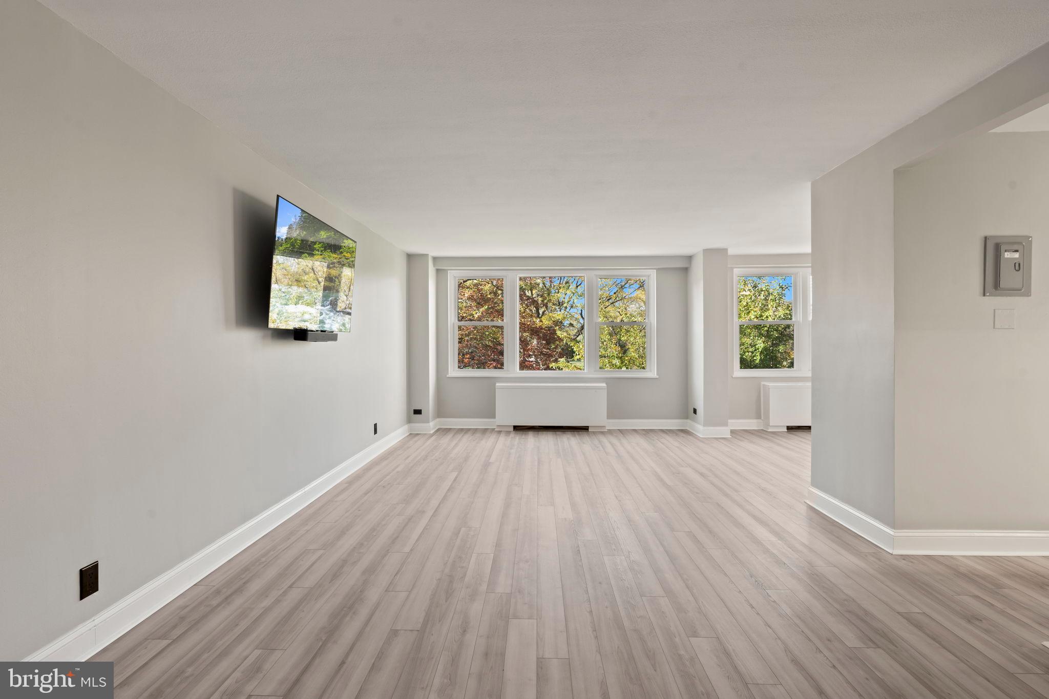 1600 Hagys Ford Road, Unit 3Y Narberth, PA 19072 - Photo 3 of 38 an empty room with wooden floor and windows