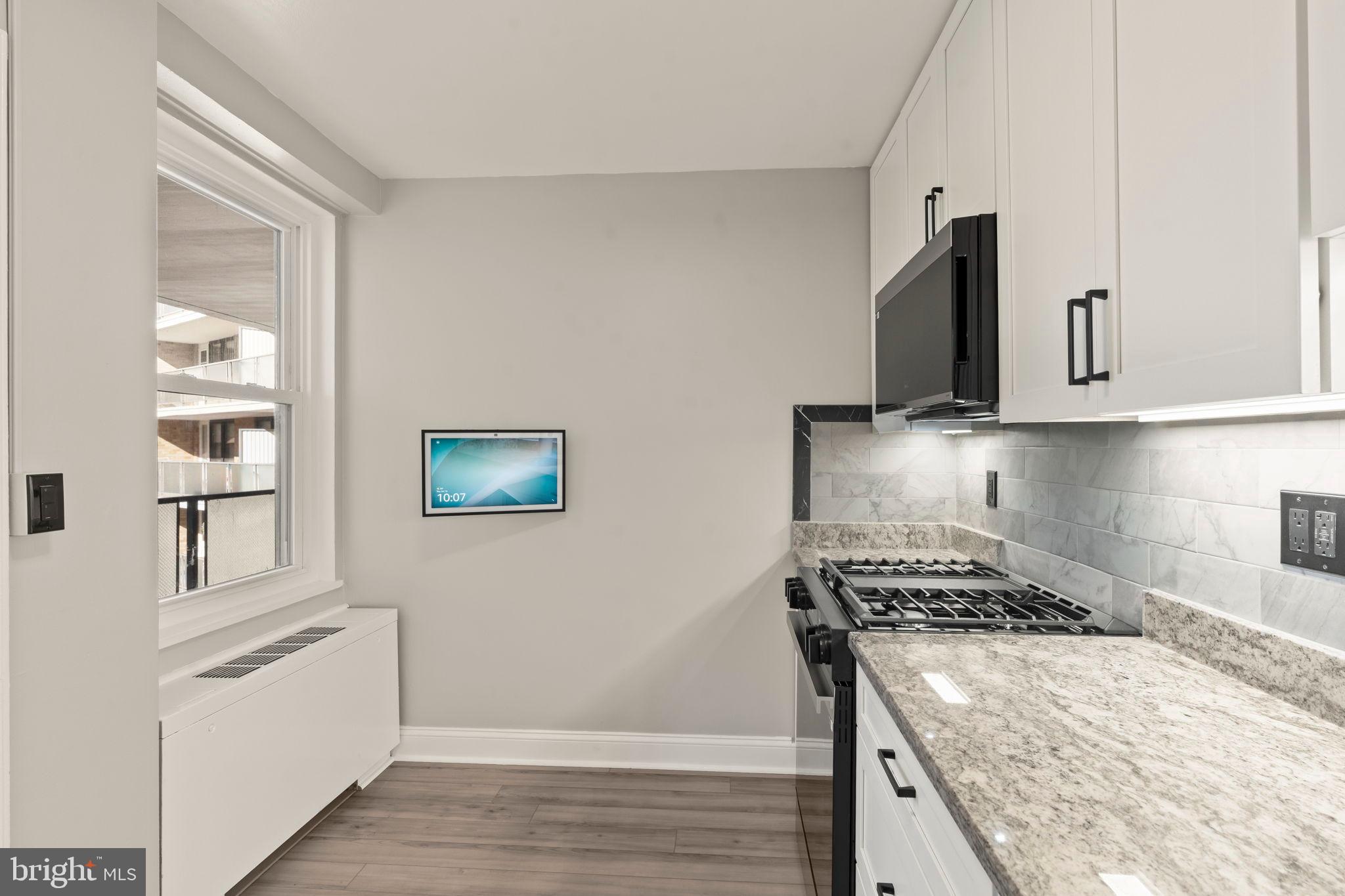 1600 Hagys Ford Road, Unit 3Y Narberth, PA 19072 - Photo 6 of 38 a kitchen with stainless steel appliances granite countertop a stove and a refrigerator