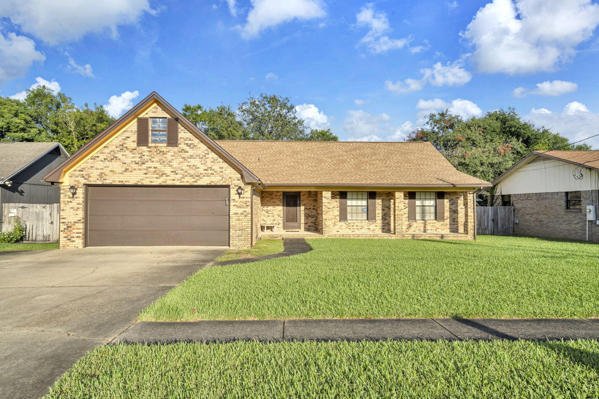 392 Evergreen Circle Destin, FL 32541 - Photo 1 of 32 a front view of a house with a garden and yard