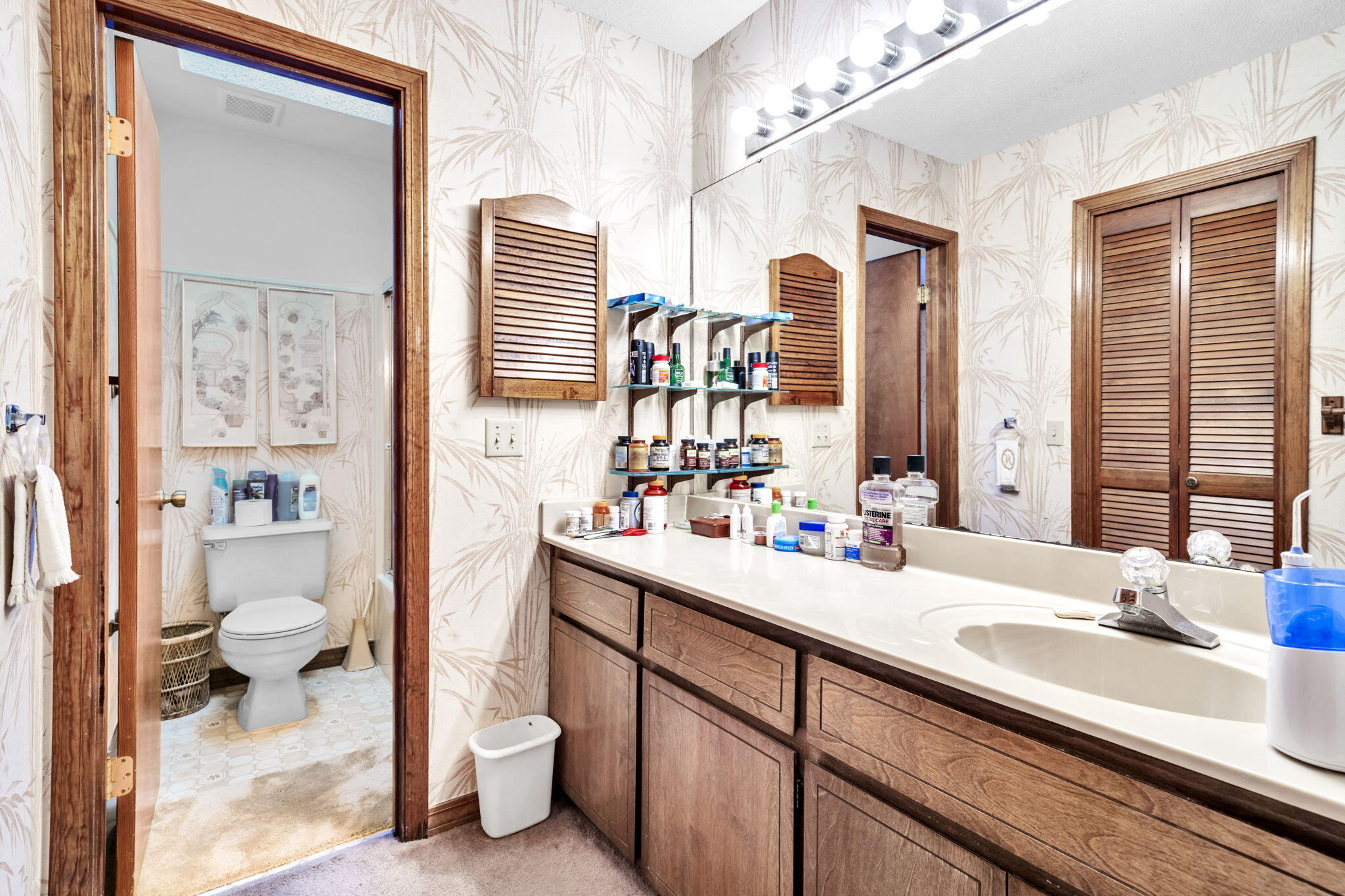 392 Evergreen Circle Destin, FL 32541 - Photo 16 of 32 a bathroom with a sink a toilet and a large mirror