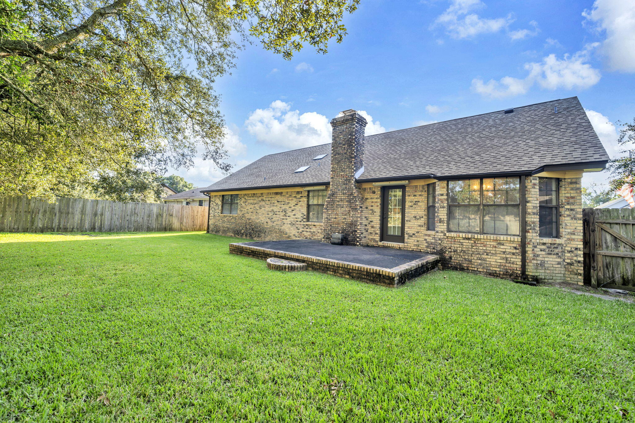 392 Evergreen Circle Destin, FL 32541 - Photo 30 of 32 a view of a house with a backyard and a patio