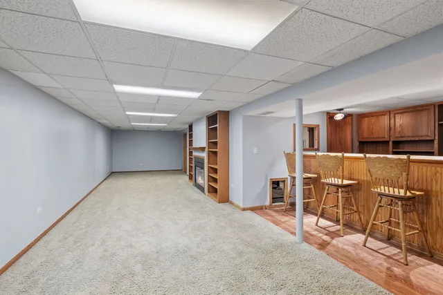 a view of a kitchen with furniture and refrigerator