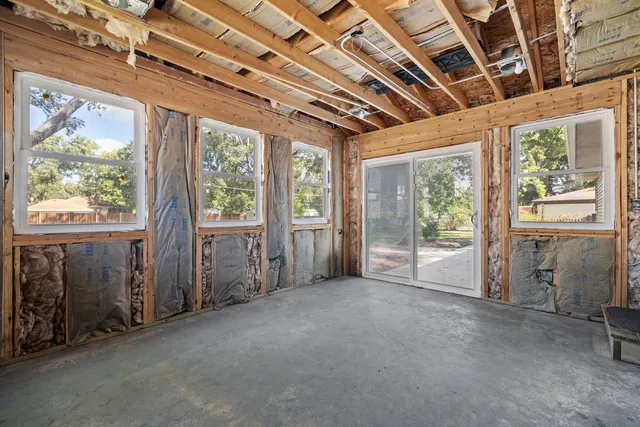 a view of an empty room with large windows