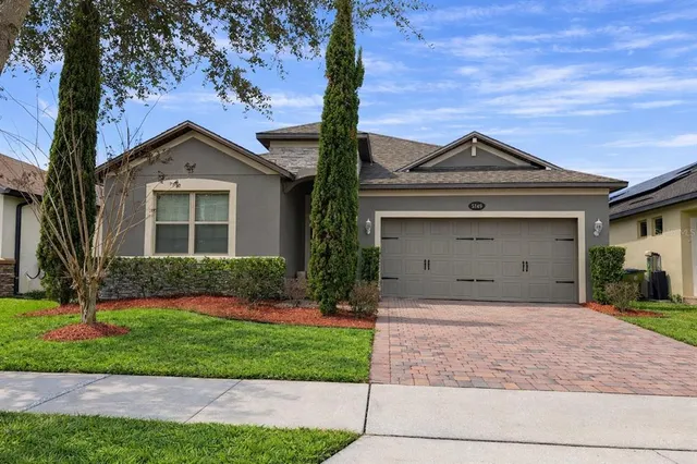 a front view of a house with a yard and garage