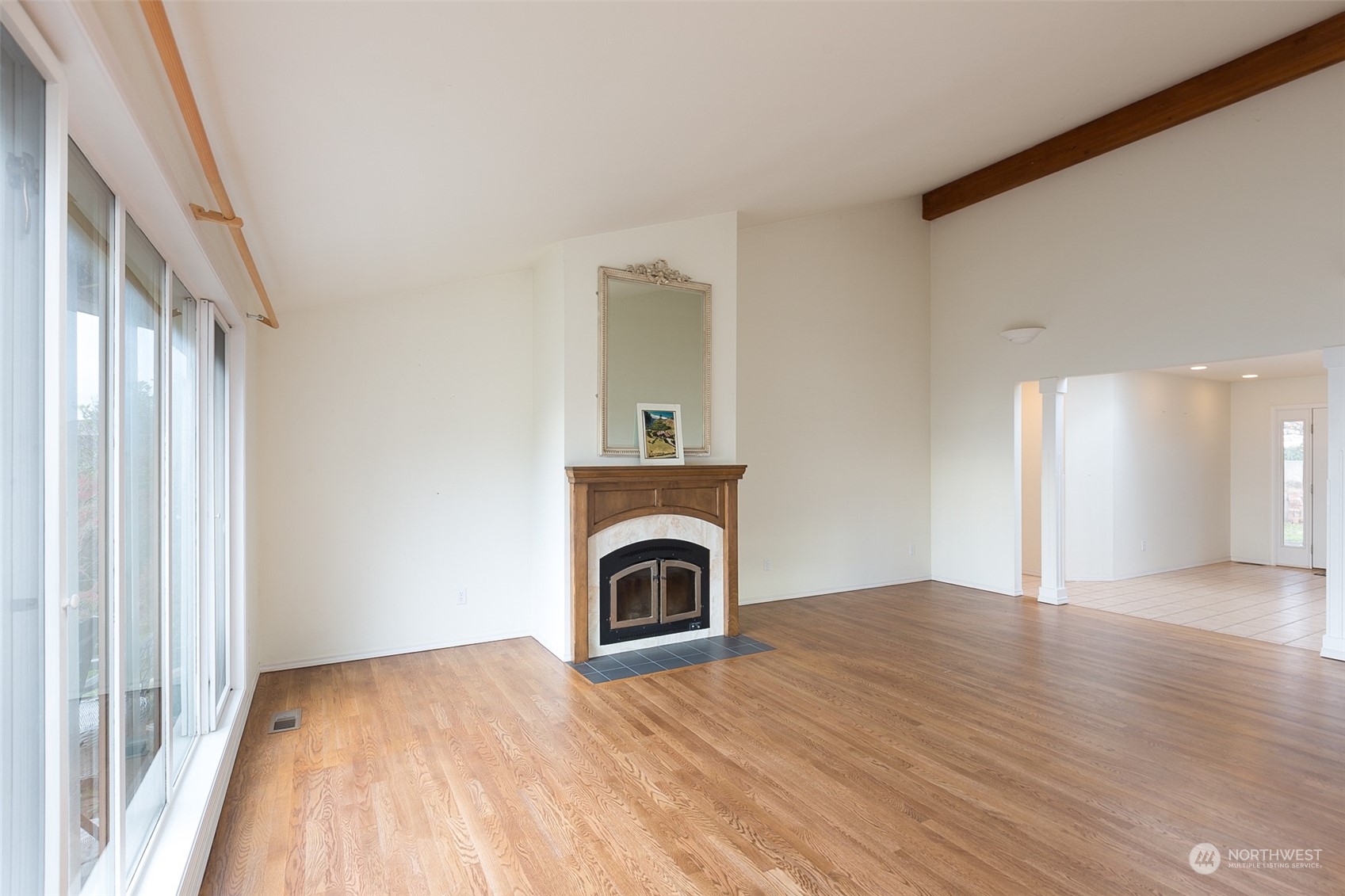 193 Mariners Point Road Sequim, WA 98382 - Photo 3 of 36 a view of a livingroom with a fireplace wooden floor and a window