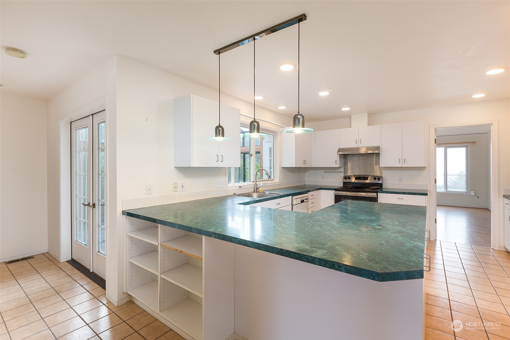193 Mariners Point Road Sequim, WA 98382 - Photo 7 of 36 a view of a kitchen with kitchen island a counter top space a sink and appliances