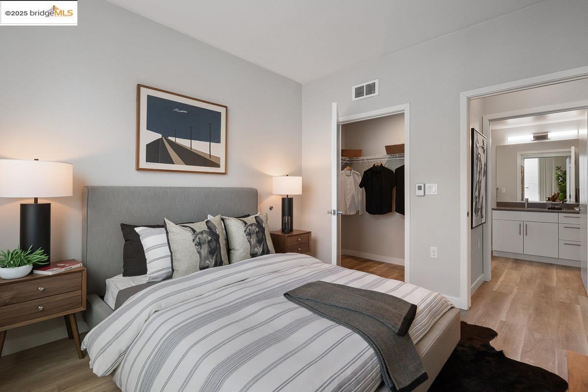 260 Brooklyn Basin Way, Unit 428 Oakland, CA 94606 - Photo 16 of 44 Bedroom with light wood-type flooring and a spacious closet