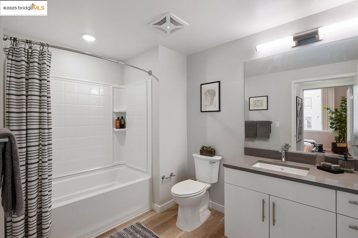 260 Brooklyn Basin Way, Unit 428 Oakland, CA 94606 - Photo 17 of 44 Full bathroom featuring shower / tub combo, light wood-style flooring, and vanity