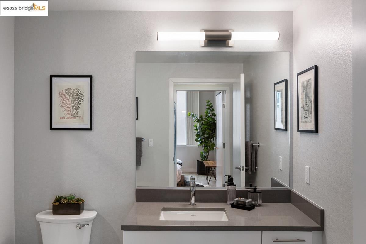 260 Brooklyn Basin Way, Unit 428 Oakland, CA 94606 - Photo 18 of 44 Bathroom featuring a textured wall and vanity
